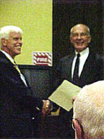 Chapter President Duane Booth presents the Chapter's newest member, Henry Goebel, Jr., with his membership certificate.