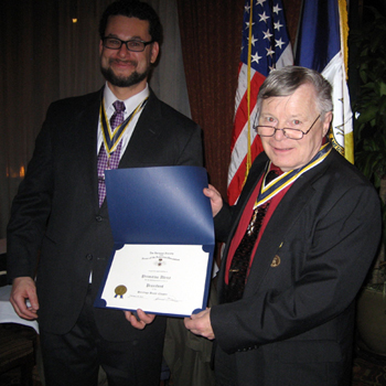 Immediate Past President Primitivo Africa receives certificate and pin from Chapter President Thomas Dunne