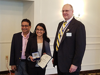 Essay Contest winner Priyanka Kumar (center), her father Aseem Kumar (left) and President Douglas Gallant