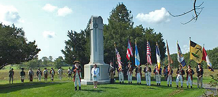Saratoga Battle Chapter SAR President Douglas Gallant (L) and Saratoga Chapter NSDAR Regent Heather Mabee (R) with the musket unit and Color Guard