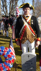 Mike stands behind his 5th great-grandfather's gravestone - Photo by Duane Booth