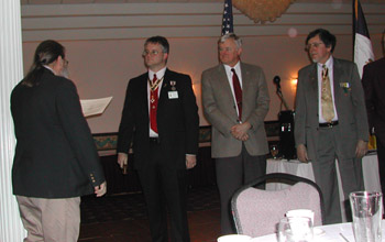 Past Chapter President Rick Saunders installs Chapter Officers: Richard H. Fullam, President; Primitivo Africa, 1st Vice-President (pictured is stand-in Peter Fullam), Dennis F. Marr, Genealogist (photo courtesy of Dianne Fullam)