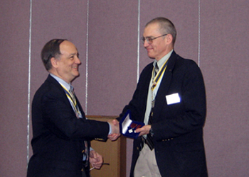 President Sage presents Peter with the Distinguished Service Award
