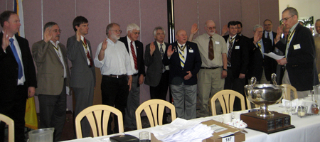 Past President Col. Peter K. Goebel installs newly elected officers and Managers