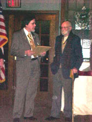 Dennis Marr presents Carl Covell with a letter outlining Carl's faithful and long-time service to the Chapter.  Carl received an enrollment in the National Society's Life Membership Program for his service to the chapter and in honor of his upcoming 90th birthday on February 26, 2003.