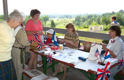 Members of the Saratoga Chapter, Daughters of the American Revolution (DAR), Bemis Heights Society and the Children of the American Revolution (CAR) distribute brochures and sell raffle tickets.