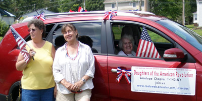 (l to r) Cheryl Doyle, Andrea Hyde, and (inside) Dorothy Mitchell, Saratoga Chapter NSDAR with their parade vehicle - Photo by Eleanor Morris